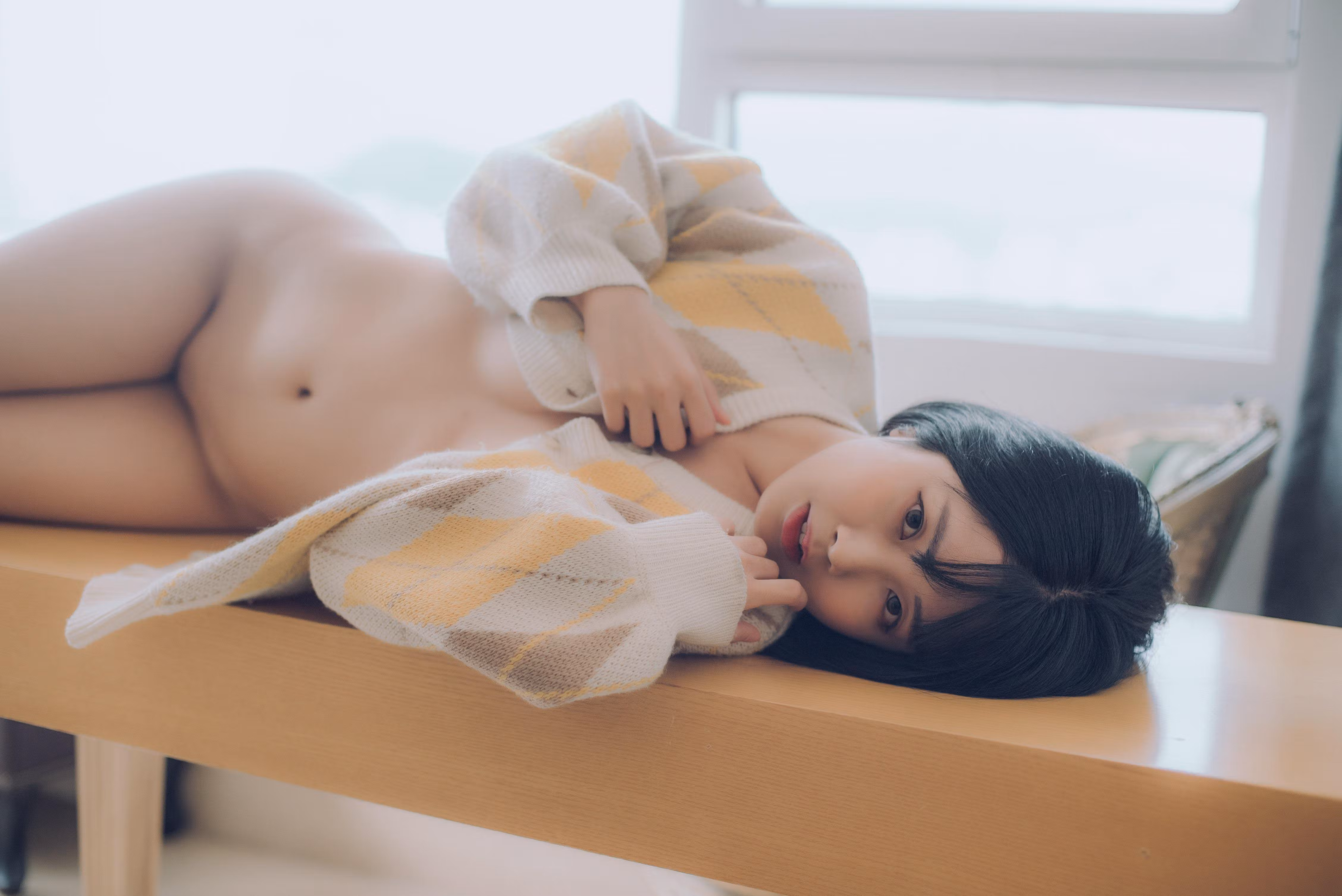 Asian model posing in minimal studio setting