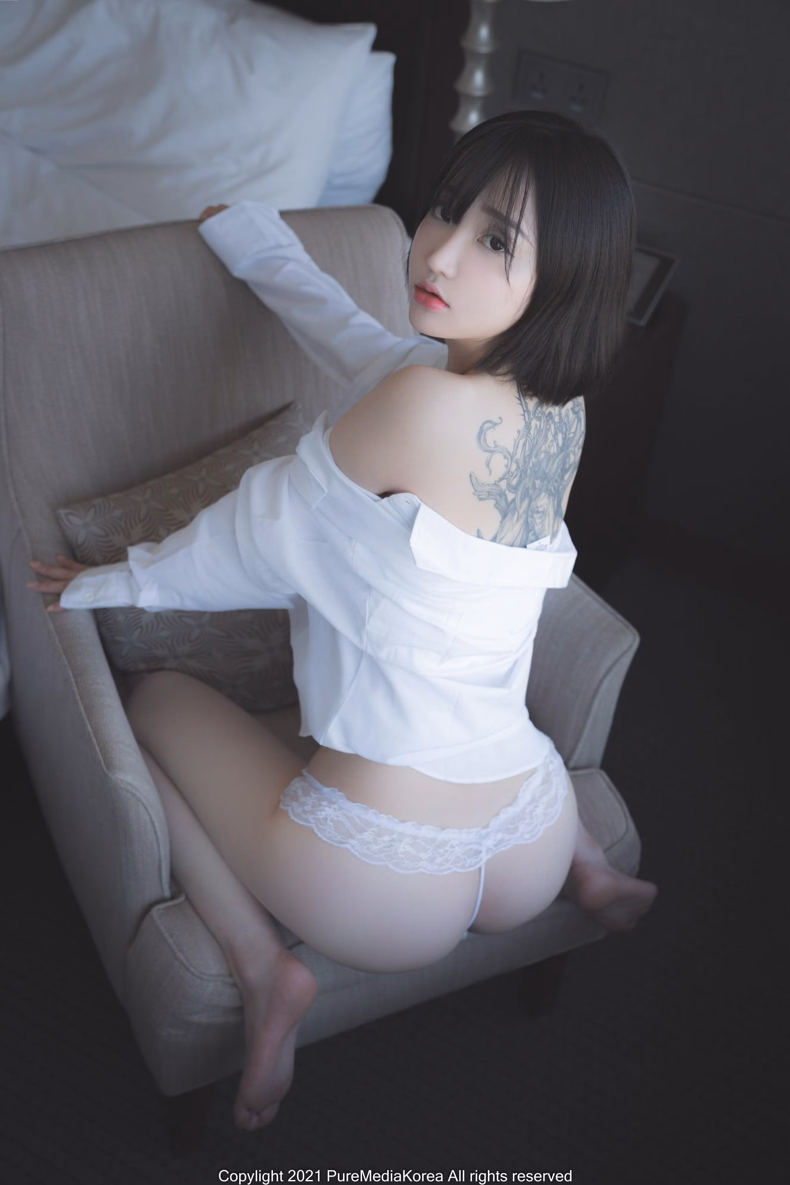 Asian model posing in minimal studio setting